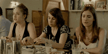 The characters from "Girls" eating at a restaurant.