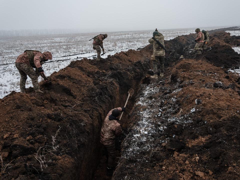 Ukrainian servicemen make a trench near Bakhmut on February 1, 2023, amid the Russian invasion of Ukraine.