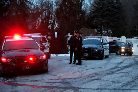 Police vehicles are seen outside the home of former U.S. President Bill Clinton and former Democratic presidential candidate Hillary Clinton after firefighters were called to put out a fire at the property in Chappaqua, New York, U.S., January 3, 2018. REUTERS/Mike Segar