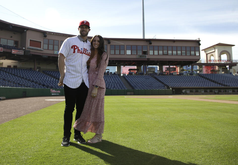 Bryce Harper, left, poses for a photo with his wife Kayla after being introduced as a Philadelphia Phillies player during a news conference at the Philadelphia Phillies spring training baseball facility, Saturday, March 2, 2019, in Clearwater, Fla. Harper and the Phillies agreed to a $330 million, 13-year contract, the largest deal in baseball history. (AP Photo/Lynne Sladky)