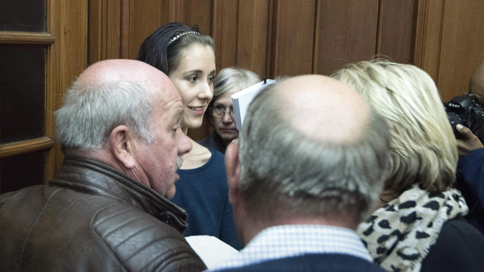 Danielle Janse van Rensburg (C), the girlfriend of convicted killer Henri van Breda (unseen) talks to members of the Van Breda family following the sentencing. Source: Getty