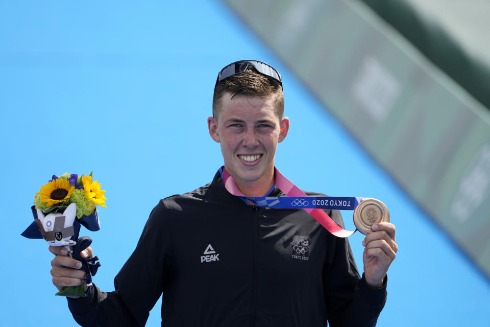 Hayden Wilde of New Zealand holds his bronze medal during a medal ceremony for the men's individual triathlon at the 2020 Summer Olympics, Monday, July 26, 2021, in Tokyo, Japan. (AP Photo/Jae C. Hong)