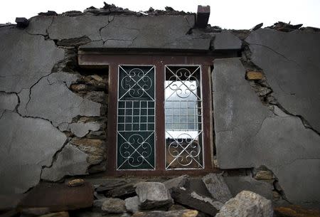 A remaining window of a collapsed house is pictured after an earthquake at Barpak village at the epicenter of the April 25 earthquake in Gorkha district, Nepal, May 21, 2015. REUTERS/Navesh Chitrakar