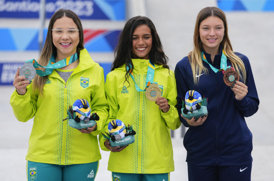 From left, Brazil's Pamela Rosa, Brazil's Rayssa Leal and Paige Heyn of United States pose at the podium of the women's skateboarding street at the Pan American Games in Santiago, Chile, Saturday, Oct. 21, 2023. (AP Photo/Esteban Felix)