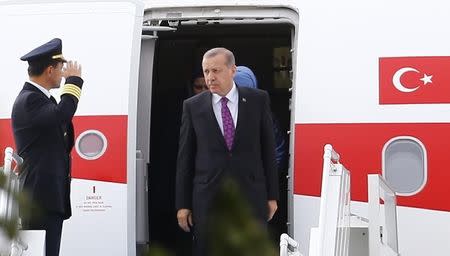 Turkish President Tayyip Erdogan (C) looks on after arriving at Esenboga Airport, in Ankara, Turkey, June 8, 2015. REUTERS/Umit Bektas