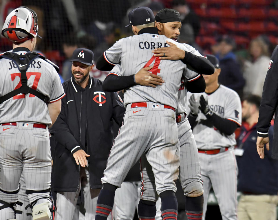 Minnesota Twins shortstop Carlos Correa (4) hugs Byron Buxton after the team's win over the Boston Red Sox in baseball game at Fenway Park, Wednesday, April 19, 2023, in Boston. (AP Photo/Mark Stockwell)