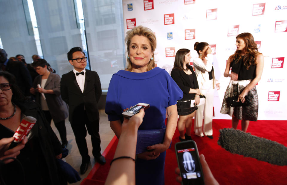 Actress Catherine Deneuve is interviewed as she arrives for the Film Society of Lincoln Center's 39th annual Chaplin Award Gala at Alice Tully Hall, Monday, April 2, 2012 in New York. (AP Photo/Jason DeCrow)