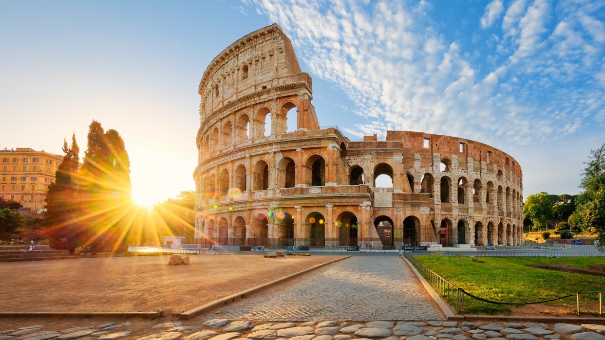 View of Colosseum in Rome and morning sun, Italy, Europe.