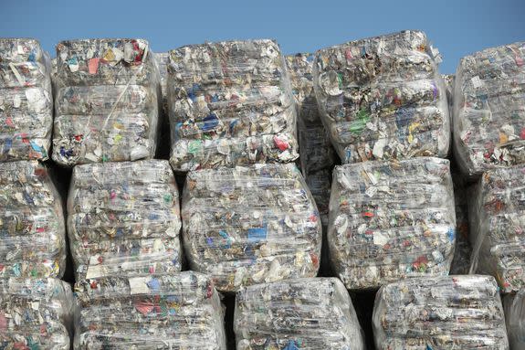 Sorted recycled materials sit in stacks outside of a recycling facility in Germany.