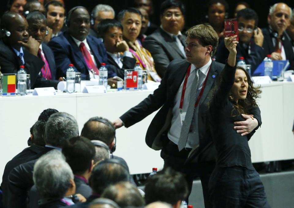 A security officer blocks a pro-Palestine protestor at the 65th FIFA Congress in Zurich