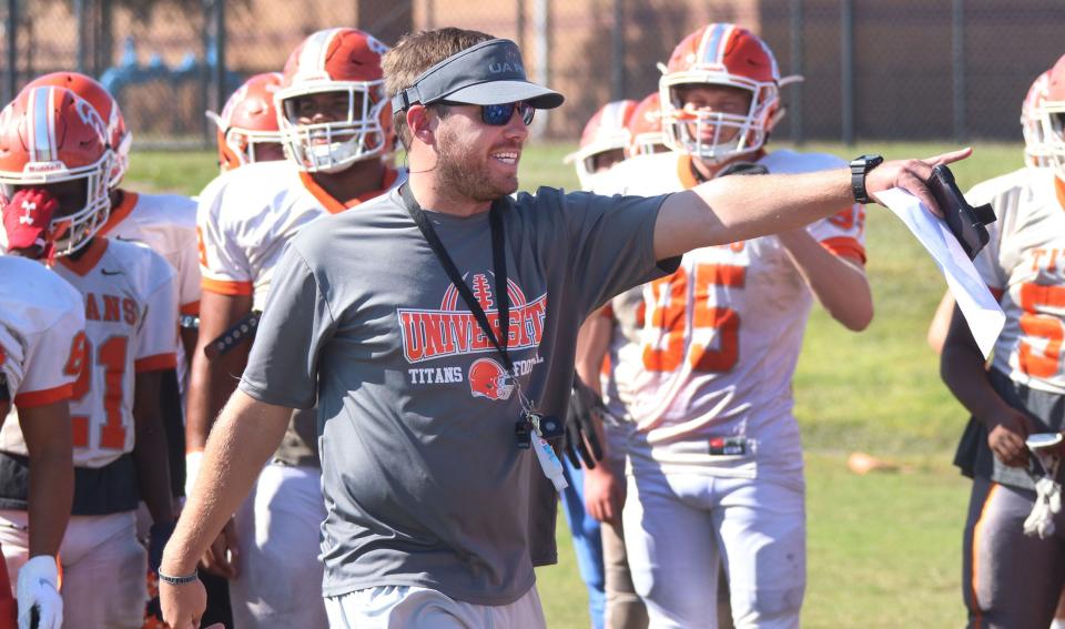 Offensive coordinator Justin Roberts gives some instructions to his University High players, Tuesday September 24, 2019 during practice.  [News-Journal/David Tucker]