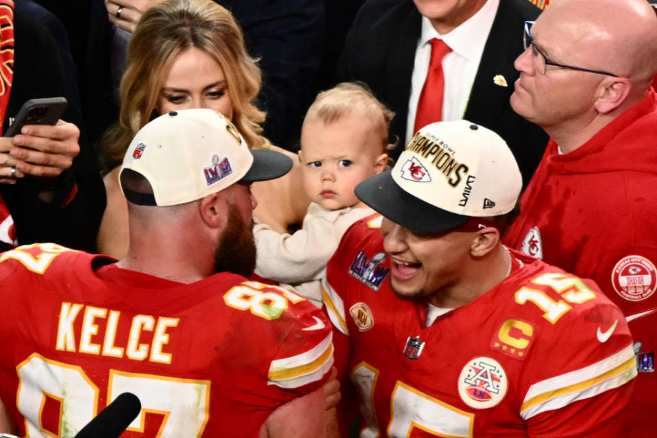 Kansas City Chiefs' quarterback #15 Patrick Mahomes (R) speaks to Kansas City Chiefs' tight end #87 Travis Kelce as his wife Brittany Mahomes holds his son Patrick Bronze after the Chiefs won Super Bowl LVIII against the San Francisco 49ers at Allegiant Stadium in Las Vegas, Nevada, February 11, 2024. (Photo by Patrick T. Fallon / AFP) (Photo by PATRICK T. FALLON/AFP via Getty Images)