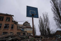 FILE - A basketball hoop and backboard stands amid the damage at a school after an airstrike by Russian forces in Chernihiv, Ukraine, Wednesday, April 13, 2022. Targeting schools and other civilian infrastructure is a war crime. Experts say wide-scale wreckage can be used as evidence of Russian intent, and to refute claims that schools were simply collateral damage. (AP Photo/Evgeniy Maloletka, File)