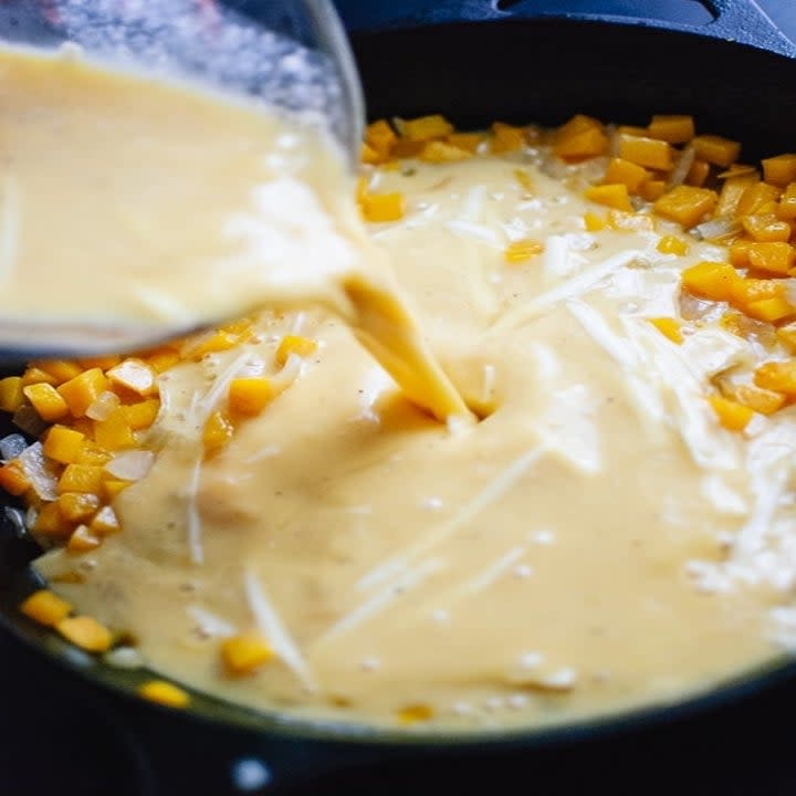 pouring egg into butternut squash mixture