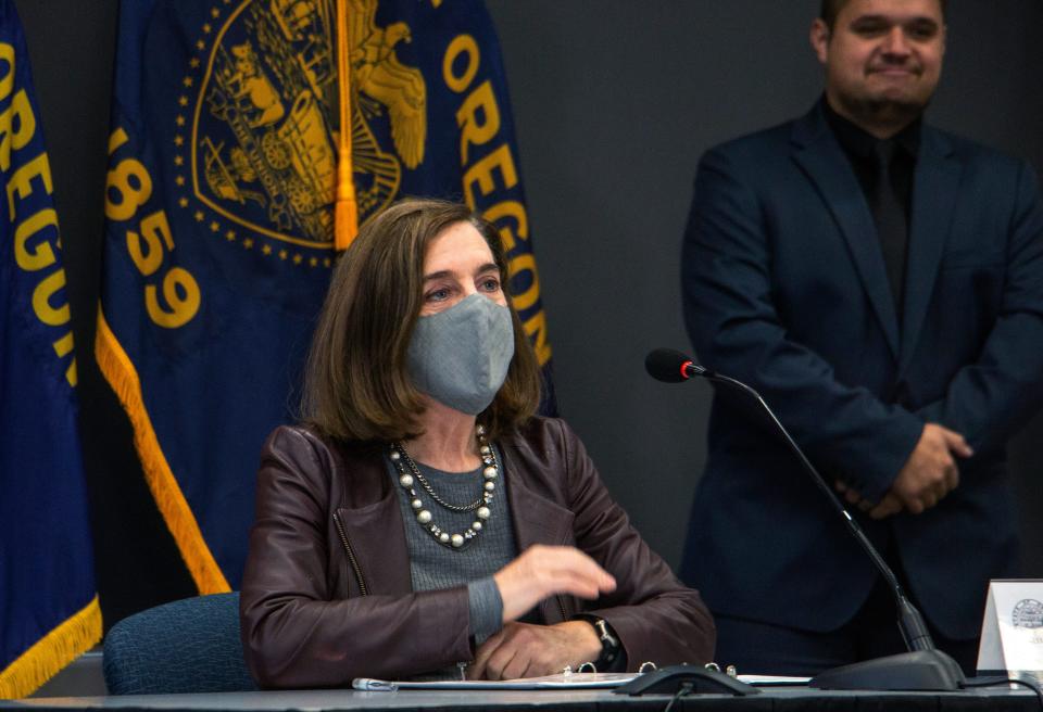 Oregon Gov. Kate Brown attends a news conference Tuesday, Nov. 10, 2020, in Portland. Brown and Oregon health officials warned Tuesday of the capacity challenges facing hospitals as COVID-19 case counts continue to spike in the state.