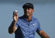 Bryson DeChambeau, of the United States, reacts to his putt on the 18th hole during the second round of the Hero World Challenge PGA Tour at the Albany Golf Club, in New Providence, Bahamas, Friday, Dec. 3, 2021.(AP Photo/Fernando Llano)