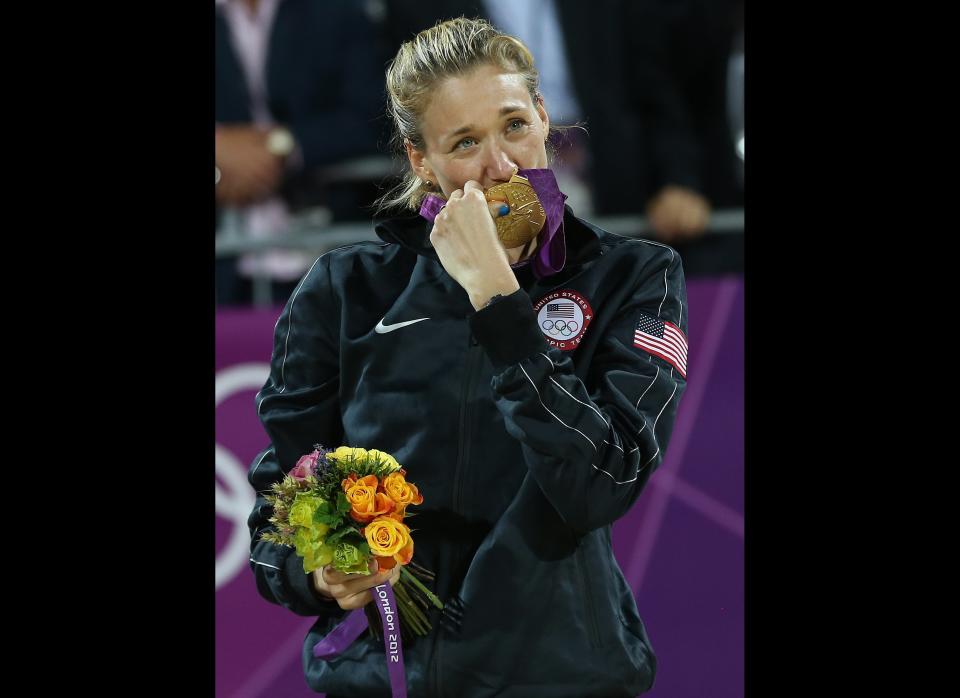 Kerri Walsh Jennings kisses her gold medal following a win over Jennifer Kessy and April Ross in the women's Gold Medal beach volleyball match between two United States teams at the 2012 Summer Olympics, Wednesday, Aug. 8, 2012, in London.