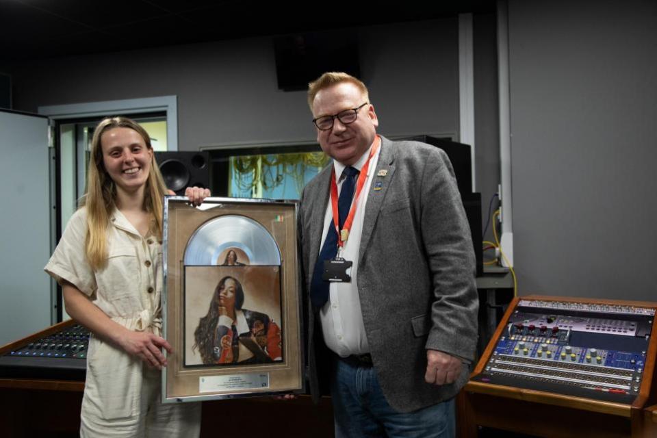 Daily Echo: Jo Howarth and Professor James Knowles with the platinum disc at Solent University