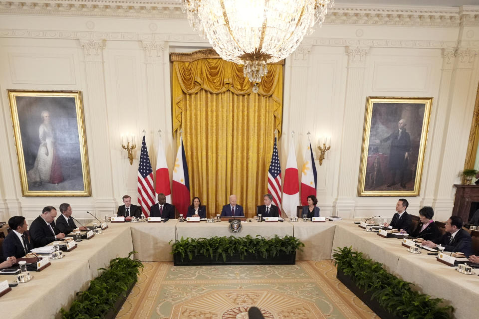 President Joe Biden, center, Philippine President Ferdinand Marcos Jr., left, and Japanese Prime Minister Fumio Kishida, right, attend a trilateral meeting in the East Room of the White House in Washington, Thursday, April 11, 2024. (AP Photo/Mark Schiefelbein)