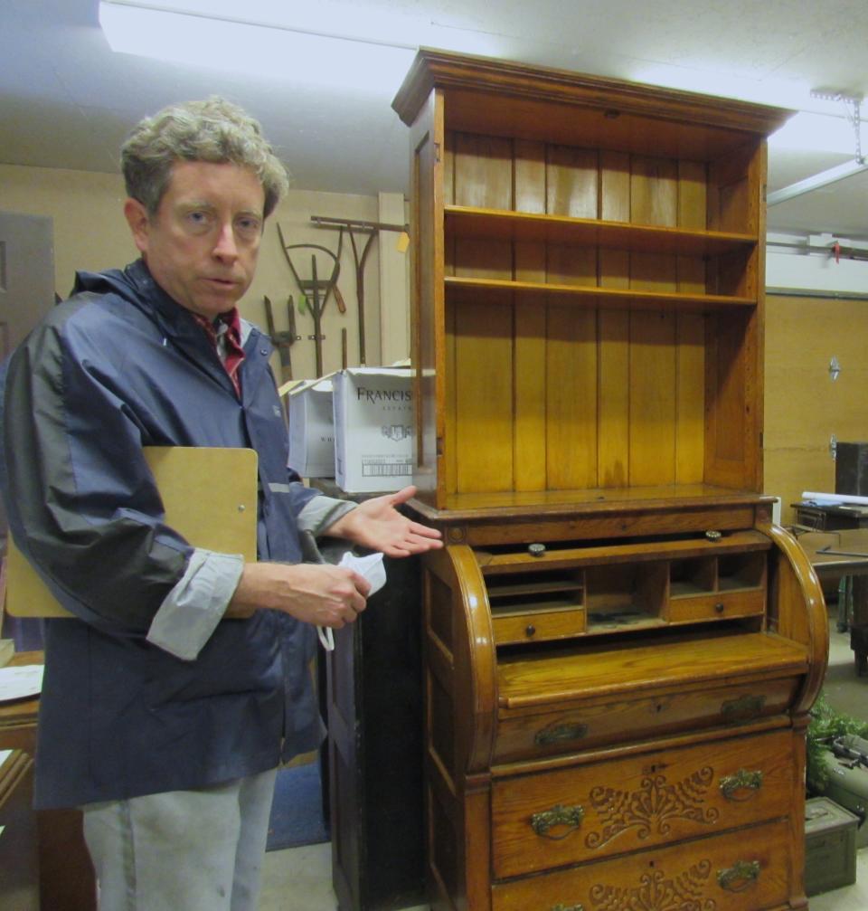 While members of the Stow Historical Society are doing what they can to help salvage the historic items that had been in the Heritage House, many items, such as larger pieces of furniture like this desk, will ultimately be sent to a professional restoration company.