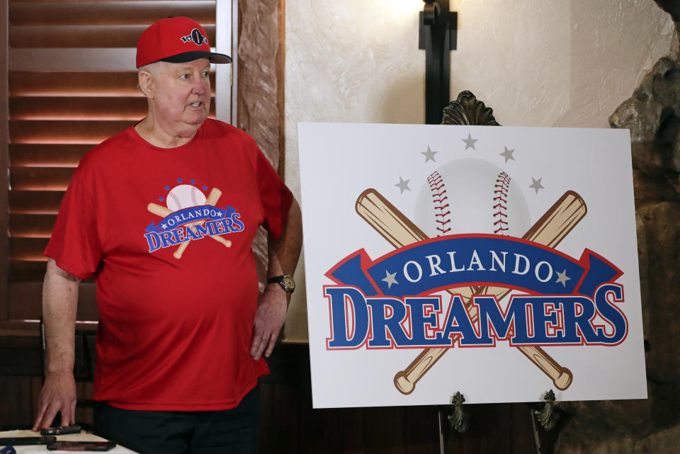 Pat Williams, co-founder of the NBA Orlando Magic basketball team, wears a T-shirt and hat with the logo 'Orlando Dreamers' while speaking at a news conference to announce a campaign to bring a Major League Baseball team to Orlando, Wednesday, Nov. 20, 2019 in Orlando, Fla.. (AP Photo/John Raoux)