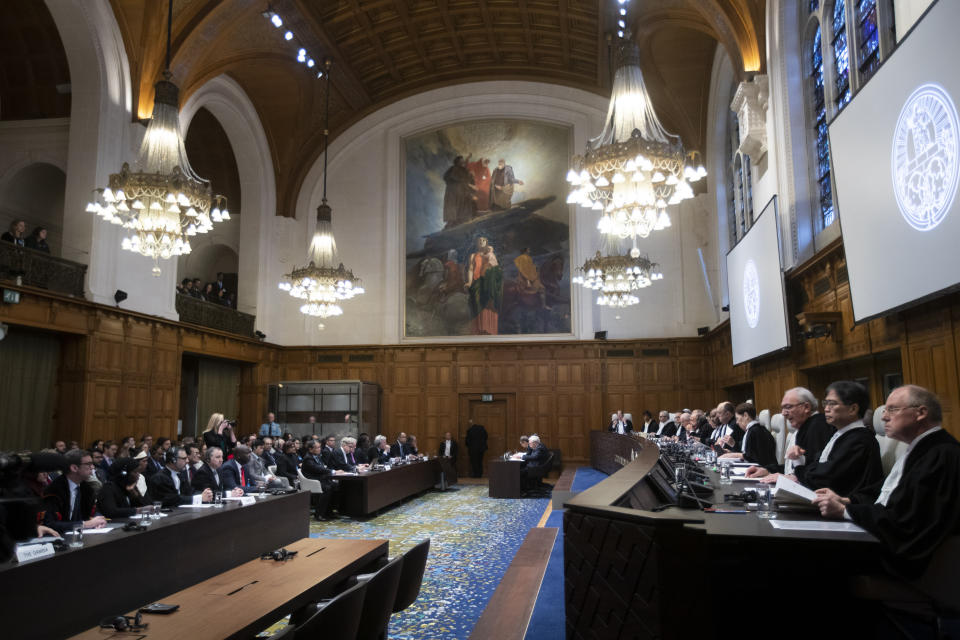 Judges take their seats prior to reading a ruling at the International Court in The Hague, Netherlands, Thursday, Jan. 23, 2020. The United Nations' top court is scheduled to issue a decision on a request by Gambia to order Myanmar to halt what has been cast as a genocidal campaign against the southeast Asian country's Rohingya Muslim minority. (AP Photo/Peter Dejong)