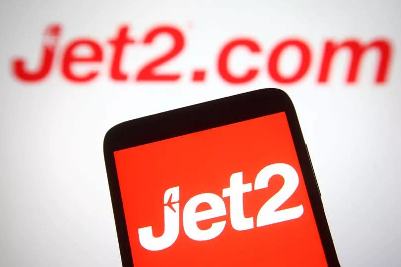 UKRAINE - 2021/07/09: In this photo illustration, Jet2 (Jet2.com) logo of a British low-cost airline is seen on a smartphone and a pc screen in the background. (Photo Illustration by Pavlo Gonchar/SOPA Images/LightRocket via Getty Images)