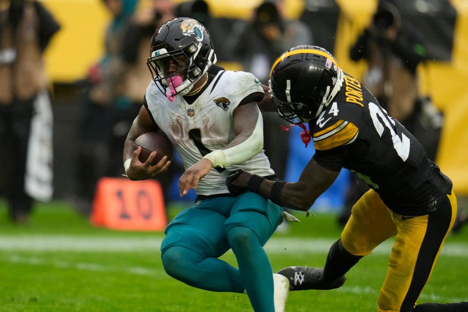 Jacksonville Jaguars running back Travis Etienne (1), seen here getting past Pittsburgh Steelers cornerback Joey Porter Jr. (24) on a 56-yard touchdown reception, has been the team's offensive MVP in the first half of the season.