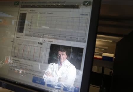 Director of Human Molecular Genetics Center Dr. Howard Jacob is reflected in a monitor at the Medical College of Wisconsin in Milwaukee May 9, 2014. REUTERS/Jim Young