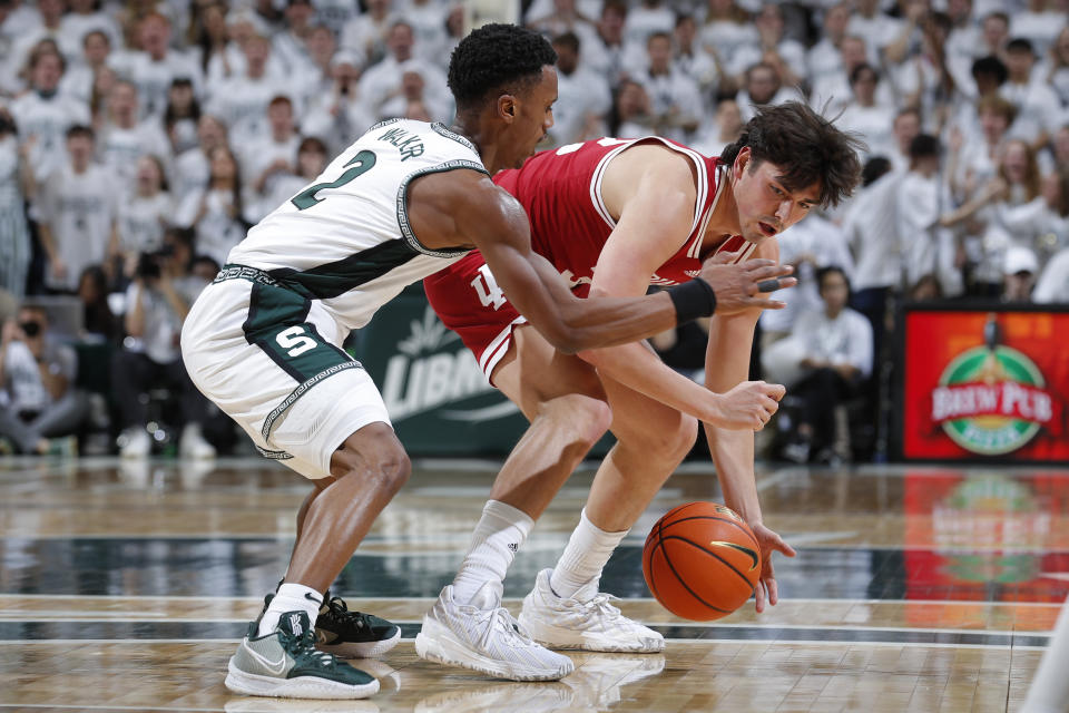 Michigan State's Tyson Walker, left, and Indiana's Trey Galloway vie for the ball during the first half of an NCAA college basketball game, Tuesday, Feb. 21, 2023, in East Lansing, Mich. (AP Photo/Al Goldis)