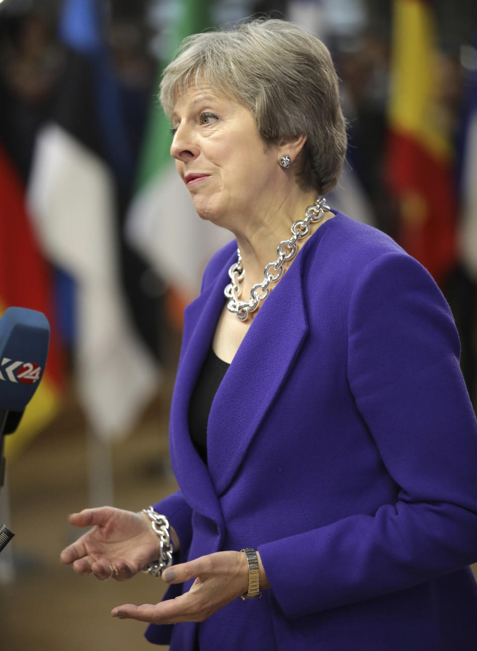 British Prime Minister Theresa May speaks with the media as she arrives for an EU summit at the Europa building in Brussels, Thursday, Oct. 18, 2018. EU leaders meet for a second day on Thursday to discuss migration, cybersecurity and to try and move ahead on stalled Brexit talks. (AP Photo/Olivier Matthys)