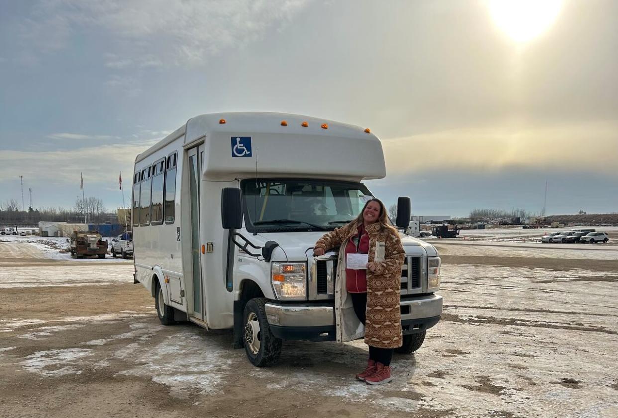 Isabelle Piché of Adventure Time and her new shuttle bus. The shuttle service starts this week and will connect Whitehorse and Haines Junction 3 days per week, on Mondays, Wednesdays and Friday.  (Submitted by Isabelle Piché - image credit)