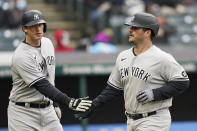 New York Yankees' DJ LeMahieu, left, and Mike Ford celebrate as they score in the third inning of a baseball game against the Cleveland Indians, Thursday, April 22, 2021, in Cleveland. (AP Photo/Tony Dejak)