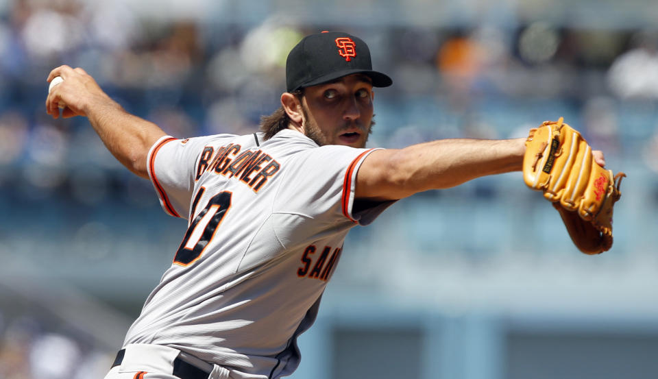San Francisco Giants starting pitcher Madison Bumgarner delivers against the Los Angeles Dodgers in the first inning in a baseball game on Saturday, April 5, 2014, in Los Angeles. (AP Photo/Alex Gallardo)