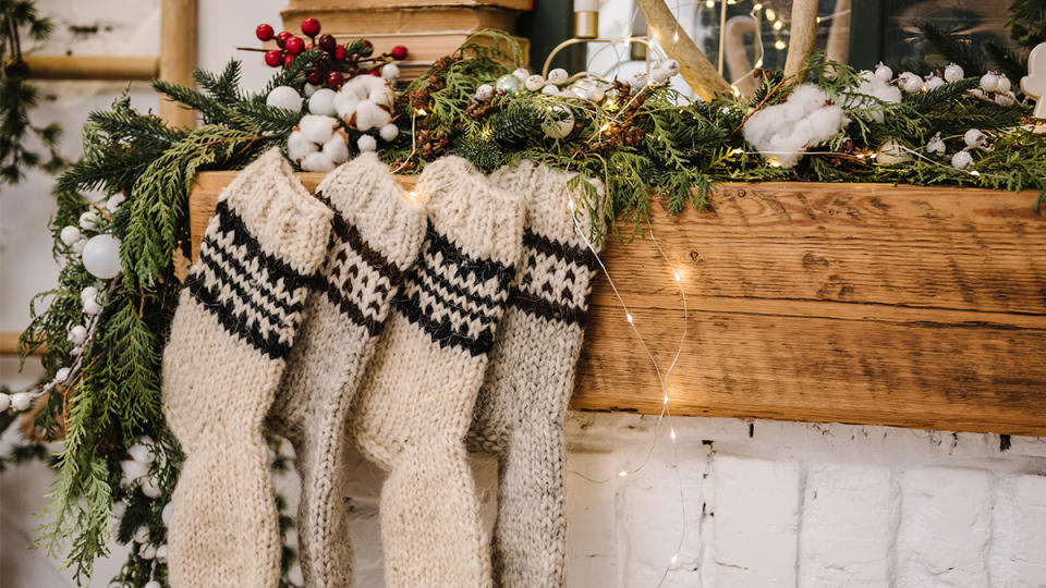 knit stockings by the fireplace: When to decorate for Christmas