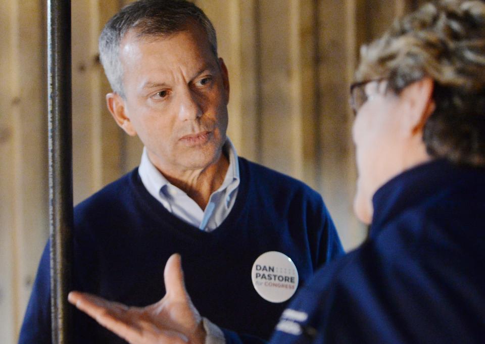 Dan Pastore, left, speaks with Erie resident Roberta McCall, 68, during a campaign meet and greet at Cellar 54.