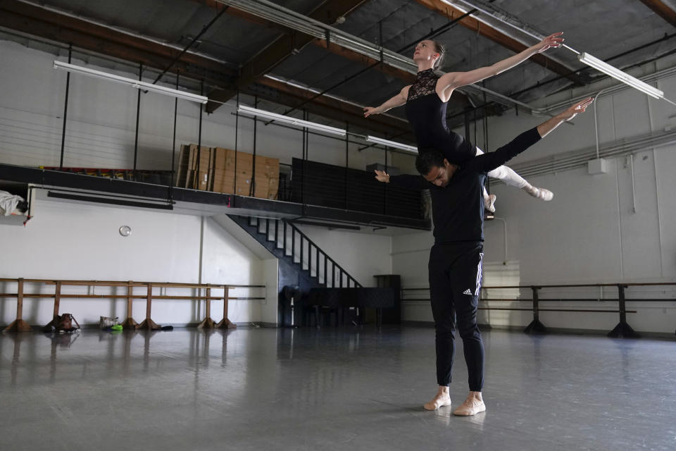 Adrian Blake Mitchell and Andrea Laššáková, top, rehearse on Monday, April 18, 2022, in Santa Monica, Calif. The dancers left their positions at the Mikhailovsky Ballet Theatre in St. Petersburg and fled Russia ahead of the invasion of Ukraine. (AP Photo/Ashley Landis)