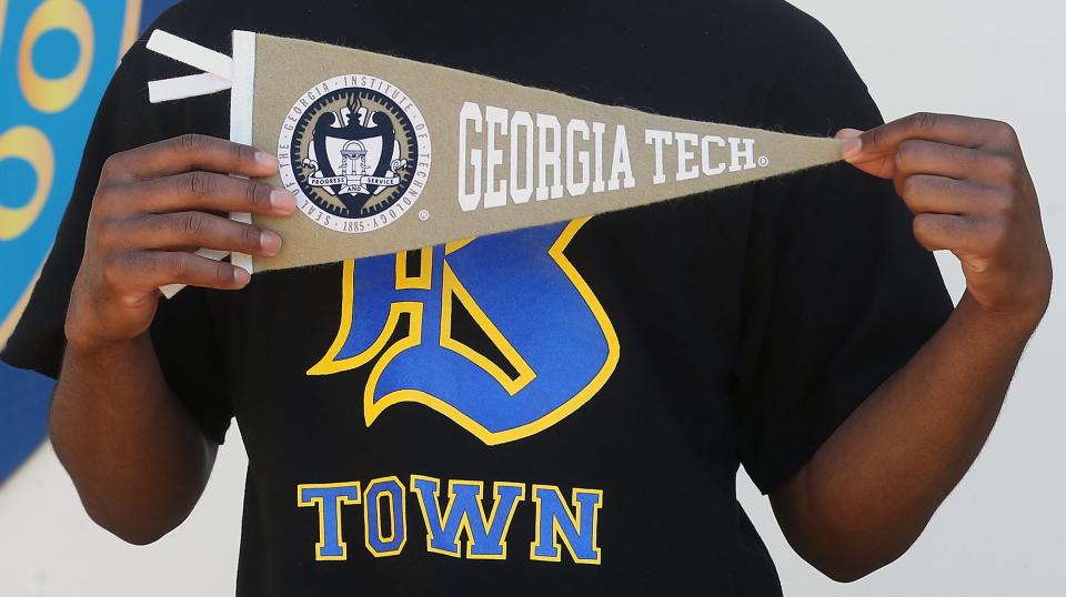 Bremerton High School co-valedictorian Kendrean Hurt holds  Georgia Tech pennant.