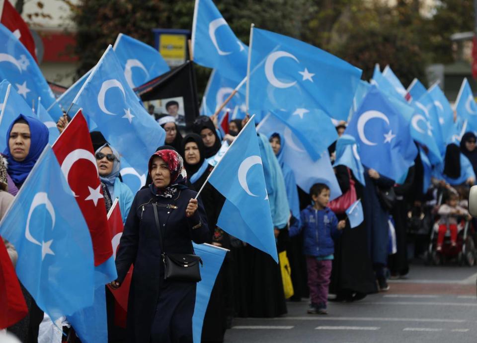 People from the Uighur community living in Turkey carry flags of what ethnic Uighurs call ‘East Turkestan’, during a protest in Istanbul on 6 November 2018 against what they allege is oppression by the Chinese government to Muslim Uighurs in the far-western Xinjiang province. (AP)