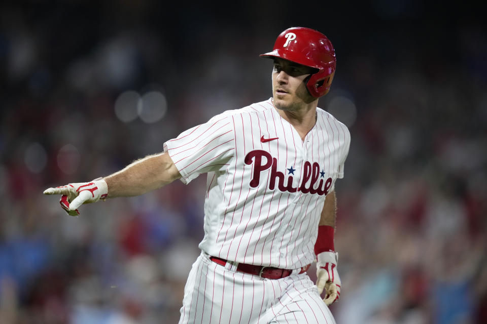 Philadelphia Phillies' J.T. Realmuto reacts after hitting a home run against Minnesota Twins pitcher Brent Headrick during the sixth inning of a baseball game, Friday, Aug. 11, 2023, in Philadelphia. (AP Photo/Matt Slocum)