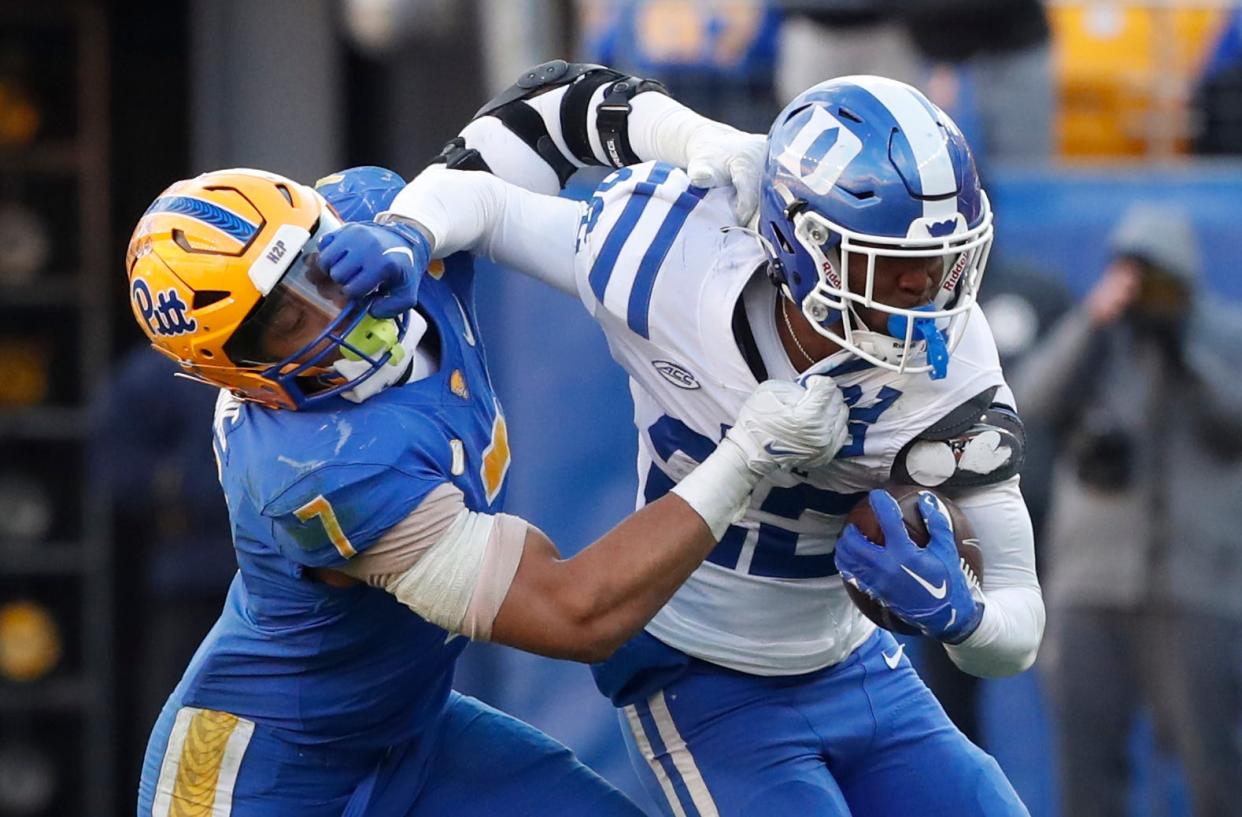 Nov 19, 2022; Pittsburgh, Pennsylvania, USA;  Duke Blue Devils running back Jaylen Coleman (22) runs after a catch against Pittsburgh Panthers linebacker SirVocea Dennis (7) during the fourth quarter at Acrisure Stadium. Pittsburgh won 28-26. Mandatory Credit: Charles LeClaire-USA TODAY Sports