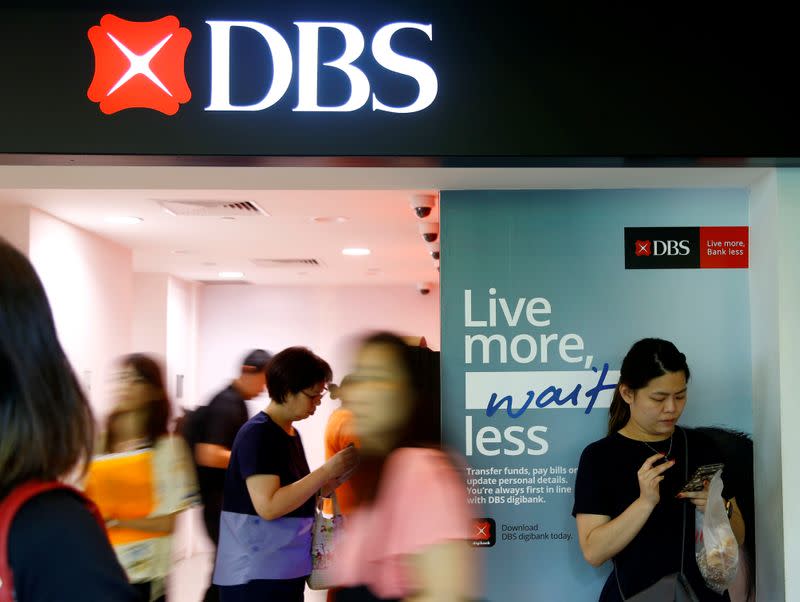 People walk past a DBS branch in Singapore