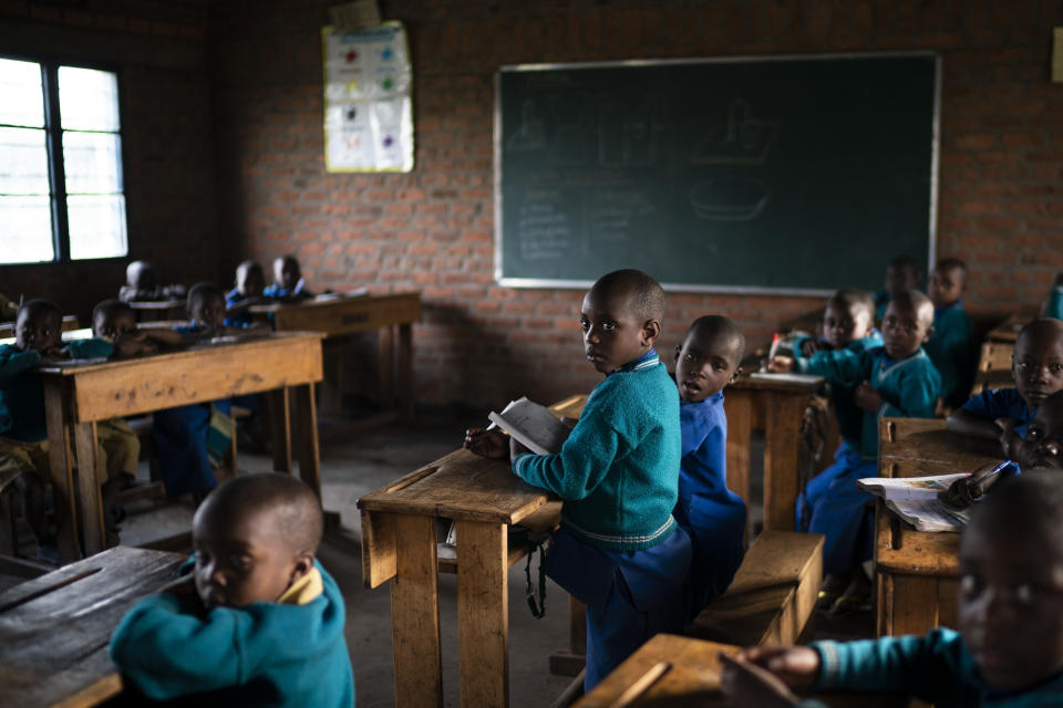 In this Sept. 5, 2019 photo, children attend class at the Nyabitsinde Primary School near the Volcanoes National Park in Kinigi, Rwanda. “The money that built this school comes from tourism,” says Fabien Uwimana, a French and English teacher. “More children today can go to school.” (AP Photo/Felipe Dana)