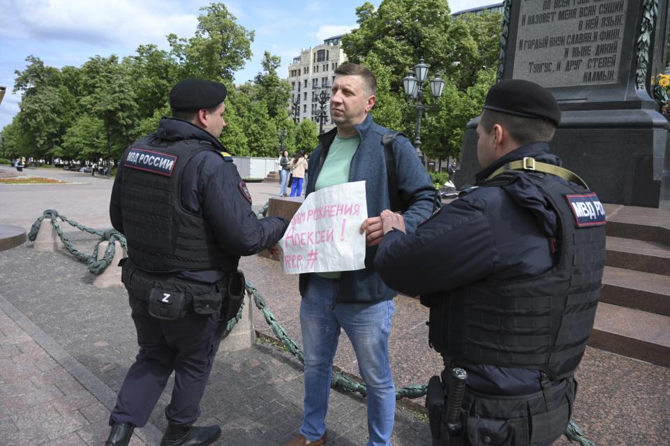 Police officers detain a demonstrator with a poster that reads: "Harry Birthday Alexei (Navalny)", in Pushkinskaya Square in Moscow, Russia, Sunday, June 4, 2023. Imprisoned opposition leader Alexei Navalny has voiced hope for a better future in Russia as his supporters held demonstrations to mark his birthday. Risking their own prison terms, some Navalny supporters in Russia marked his birthday by holding individual pickets, and other painted graffiti. Police quickly detained many for questioning. (AP Photo)