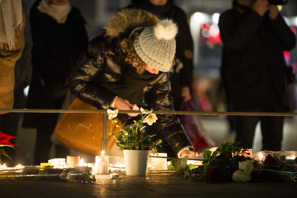 A Mourner seen lighting a candle at the Christmas market in Strasbourg France, on Dec. 12, 2018. Mourners gathered near the Strasbourg Christmas market where candles had been lit in remembrance of the victims. (Photo by Elyxandro Cegarra/SOPA Images/LightRocket via Getty Images)