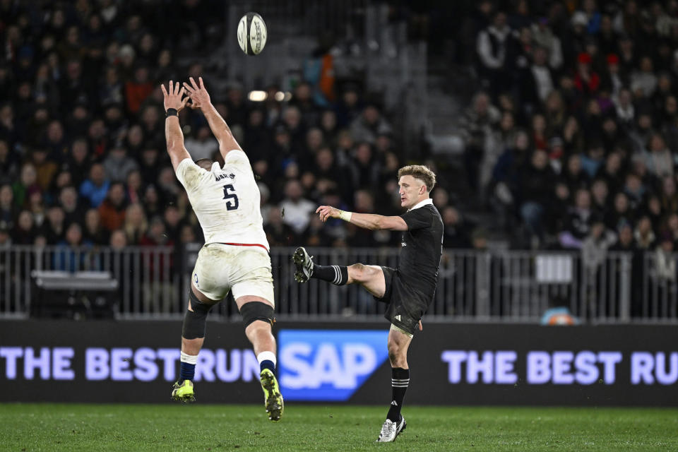 England's George Martin attempts to block a kick from New Zealand's Damian McKenzie during their rugby union test match in Dunedin, New Zealand, Saturday July 6, 2024. (Andrew Cornaga/Photosport via AP)