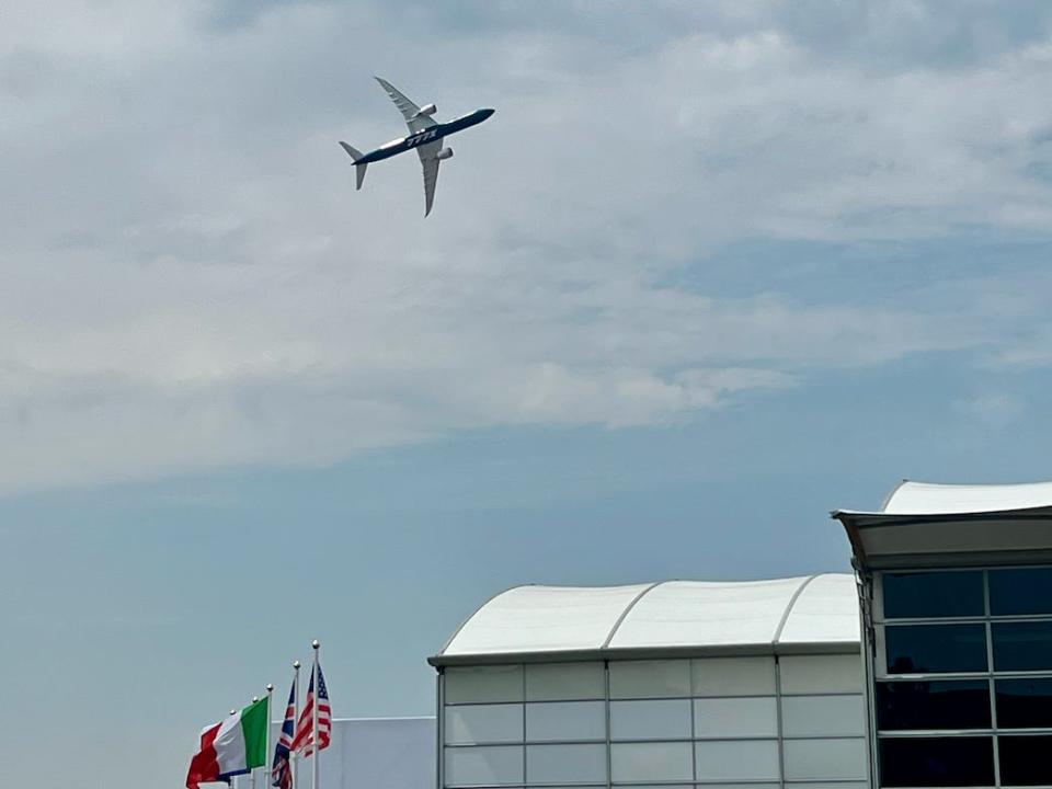 The 777X airplane flying over England in 2022.