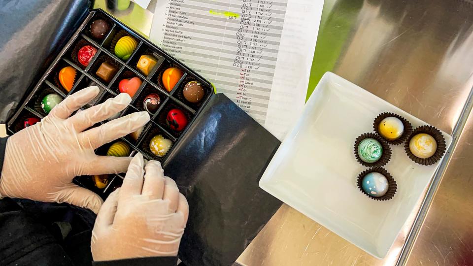 A box of chocolates is assembled. Chef and famed chocolatier Norman Love of Fort Myers made a longtime dream come true in November when he opened his first dessert restaurant in Sarasota. Love has big plans for 2021, many of them spurred by the pandemic. 