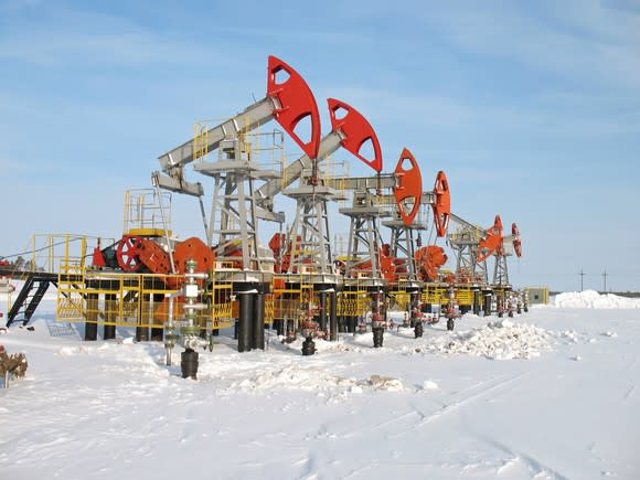 A row of oil pumps in the snow.
