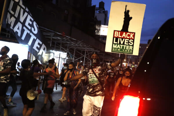 A protester holds a Black lives matter flag at a rally in Foley Square on July 30, 2020 in New York City. in support of the Black Lives Matter and Black Woman’s movement. (Photo by John Lamparski/NurPhoto via Getty Images)